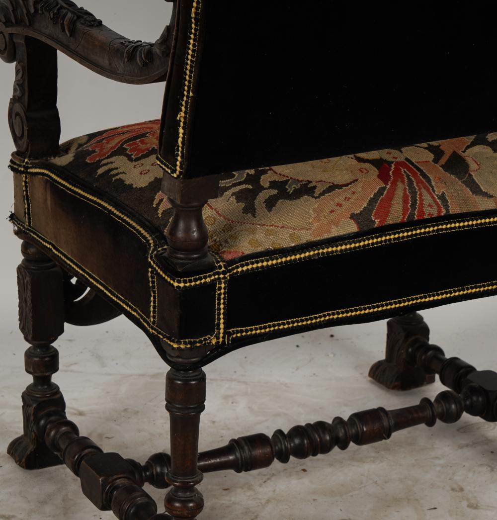 AF2-035: ANTIQUE LATE 19TH CENTURY SPANISH COLONIAL REVIVAL CARVED ARMCHAIR WITH NEEDLEPOINT UPHOLSTERY