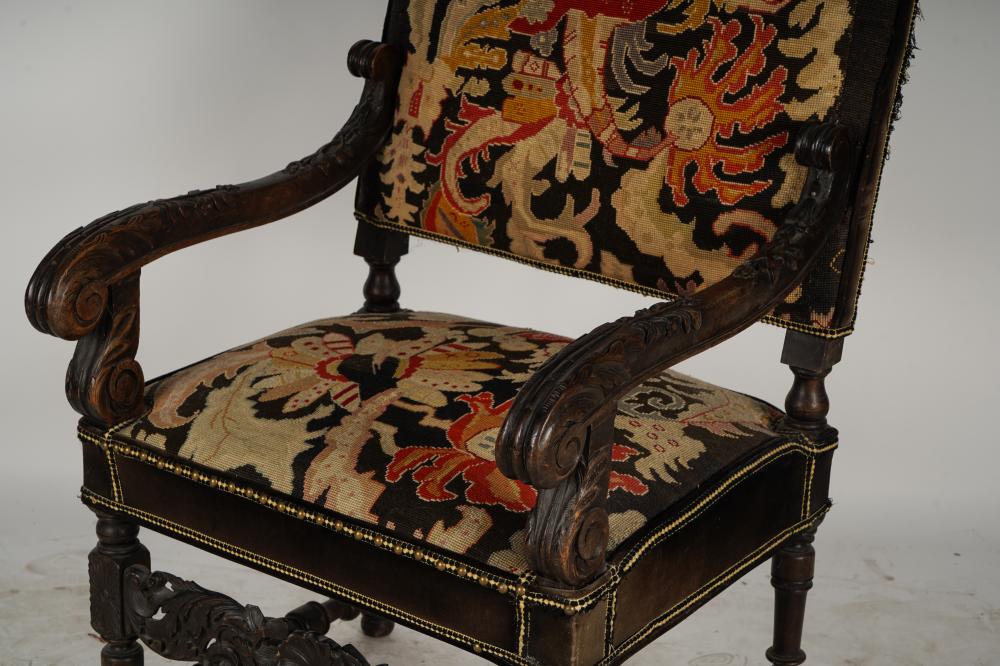 AF2-035: ANTIQUE LATE 19TH CENTURY SPANISH COLONIAL REVIVAL CARVED ARMCHAIR WITH NEEDLEPOINT UPHOLSTERY