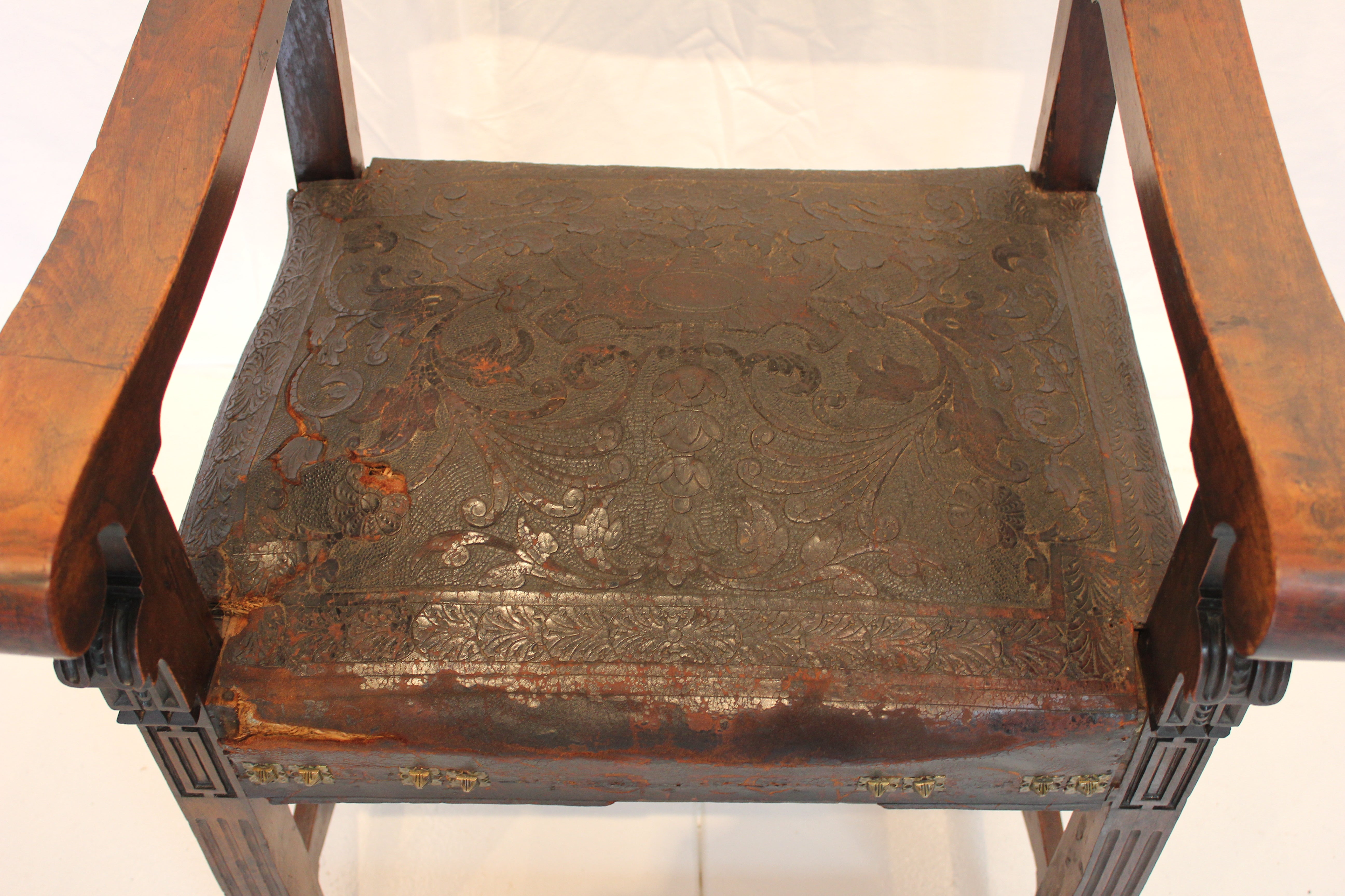 AF2-318: Antique Late 19th Century Highly Carved Walnut Spanish Colonial Arm Chair with Tooled Leather Upholstery